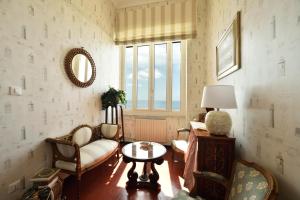 a living room with a couch and a table and a window at Casa d'artista B&B in Alassio