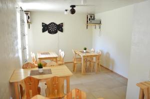 a dining room with wooden tables and chairs at Przystań Park Dolny in Szczawnica