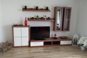 a living room with a flat screen tv on a cabinet at An der Norf 65 bitte beachten Sie die check-in und check-out Zeiten in Neuss