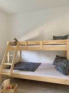 a bunk bed with a cat sitting on the bottom bunk at Kristalni Slap Kravice in Ljubuški