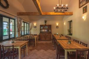 a restaurant with wooden tables and chairs and a bar at Penzion Rejštejn in RejÅ¡tejn