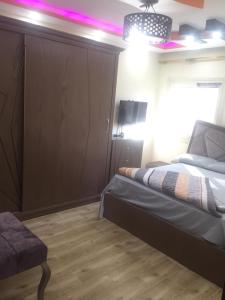 a bedroom with a bed and a purple light at Stanley Apartment - Sea View - Free Parking in Alexandria