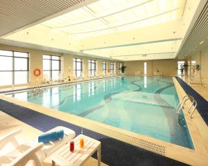 a large swimming pool in a large building at Wyndham Grand Plaza Royale Changsheng Jiangyin in Jiangyin