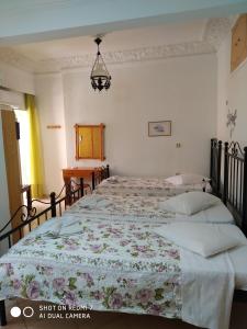 A bed or beds in a room at HERMOUPOLI ROOMS