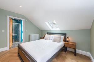 a bedroom with a large bed and a window at City Centre, Newly Refurbished Stylish Apartment in Edinburgh