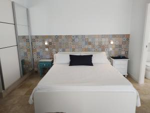 Ένα ή περισσότερα κρεβάτια σε δωμάτιο στο Quintero Suites