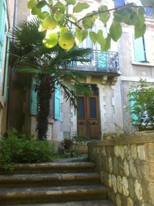 a house with a tree and stairs in front of it at Villa BeauSoleil in Digne-les-Bains