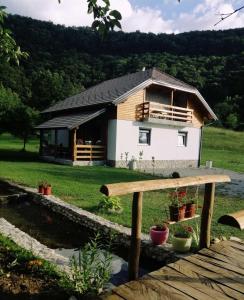 a small house in the middle of a field at Vacation House Studenac in Bihać