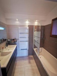 a bathroom with two sinks and a shower and a tub at Côte d'Azur Villa Amicalement Hôte in Coursegoules