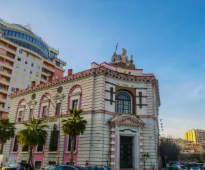 a building with a statue on the top of it at Hotel Durres Vila 53 in Durrës