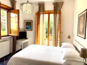 a bedroom with a white bed and a window at B&B Amendola in Bari