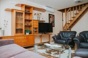 a living room with a couch and a tv at Apartment Bor in Bovec
