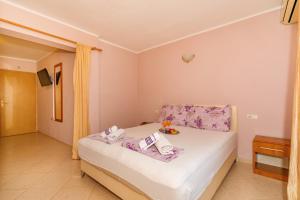 a bedroom with a bed with a tray of food on it at Guest House Edita in Ulcinj