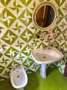 a bathroom with a sink and a mirror at B&B Amendola in Bari