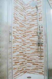 a bathroom with a shower with a glass door at Apartment Bor in Bovec