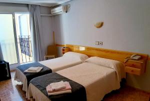 Postel nebo postele na pokoji v ubytování Hotel Alaska