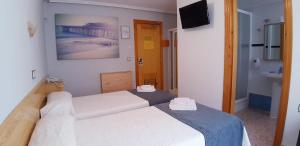 Postel nebo postele na pokoji v ubytování Hotel Alaska