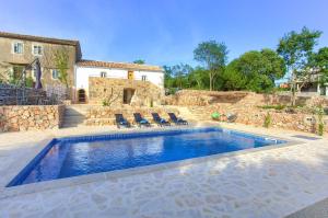 a swimming pool in front of a house at Villa MAY in Gostinjac