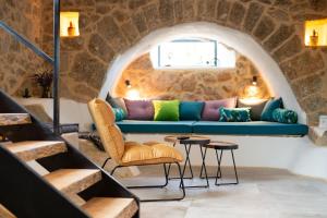a living room with a blue couch and chairs at Villa MAY in Gostinjac