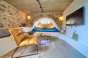 a living room with a couch and a table at Villa MAY in Gostinjac