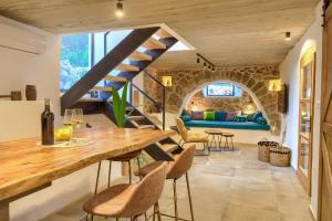 a living room with a wooden table and a staircase at Villa MAY in Gostinjac +49 photos