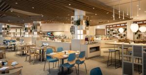 a restaurant with tables and chairs and a bar at Eden Hotel by Maistra Collection in Rovinj