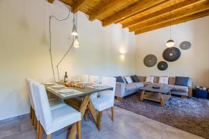a dining room with a table and a couch at Villa Skyphos in Ammoudari