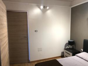 a bedroom with a door and a bed and a lamp at Civico19 in Sassari