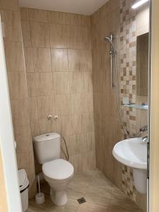 a bathroom with a toilet and a sink at Guest Rooms Nia Elis Kiten in Burgas City