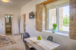 a dining room with a table and a window at G&K Stone Suites in Haraki