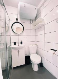 a white bathroom with a toilet and a sink at Nad Rozlewiskiem in Bobolin +47 photos