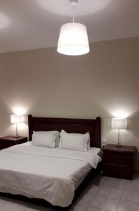 a bedroom with a large bed with two night stands at شقق بيت الوهد للشقق المخدومة in Riyadh