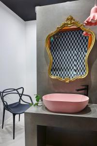 a bathroom with a sink and a mirror and a chair at Sielanka in Ustroń