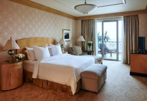 a hotel room with a large bed and a balcony at Four Seasons Hotel Cairo at Nile Plaza in Cairo