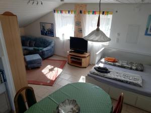 a living room with a table and a couch at Stadldorf» Ferienwohnung Wagner in Kirchroth
