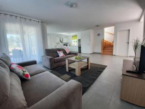 a living room with a couch and a table at VILLA AMBER YourCroatiaHoliday in Drenje