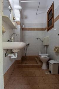 a bathroom with a sink and a toilet at Dora Studios in Parga