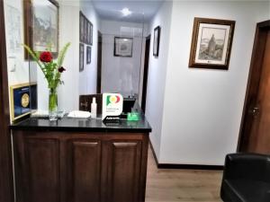 a room with a desk with a vase of flowers on it at Hotel Domus in Coimbra