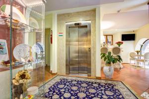 a lobby with a glass door and a tile floor at Hotel Volterra In in Volterra