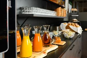 three bottles of orange juice on a counter in a kitchen at Hotel Alte Post - Grossarl in Grossarl