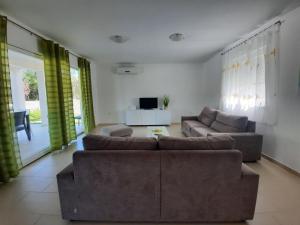 a living room with two couches and a television at VILLA DIAMOND YourCroatiaHoliday in Drenje