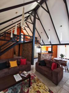 a living room with two couches and a table at Hunter Habit Cottages in Rothbury