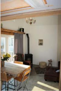 a living room with a bed and a fireplace at Have a nice stay! - Beach Cottage free parking in Noordwijk aan Zee