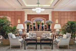 a lobby with a couch and chairs and a chandelier at Four Seasons Hotel Cairo at Nile Plaza in Cairo +37 photos