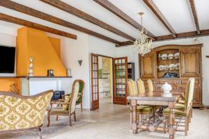 a dining room with a wooden table and chairs at Les Vignes de Carcassonne - Piscine et clim in Capendu