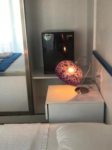 a room with a bed and a lamp and a tv at Rota Hotel in Dalyan