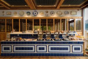 a kitchen with blue and white plates on the wall at The Whispering Pine Lodge in Letterfinlay