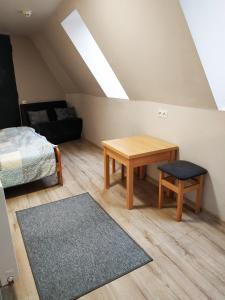 a bedroom with a bed and a table and a couch at Bracka 4 Apartament in Krakow