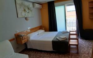 Postel nebo postele na pokoji v ubytování Hotel Alaska