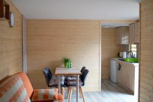a small kitchen with a table and chairs in a room at Pogodny Domek in Mielno